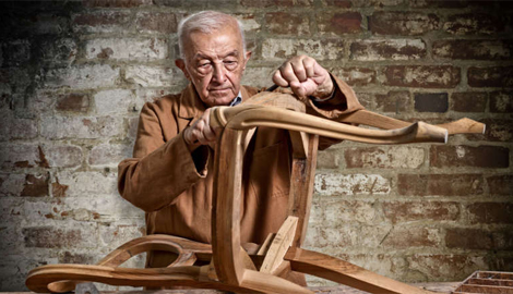 A skilled older man focuses on constructing a wooden chair, highlighting his craftsmanship and attention to detail - office and dry containers