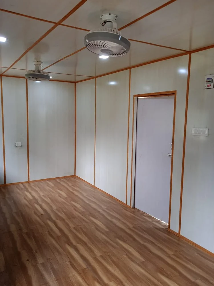A spacious cabin type office container featuring polished wooden floors and bright white walls, creating a clean and inviting atmosphere - office and dry containers