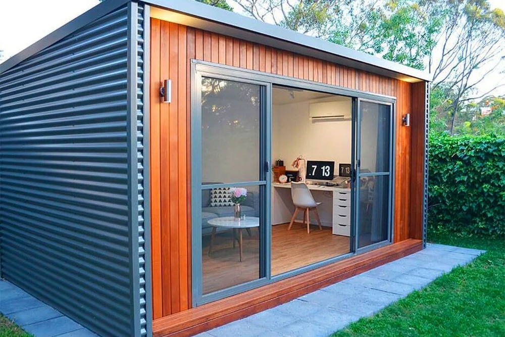 A small prefabricated shipping container office featuring a sliding door and a neatly organized desk - office and dry containers