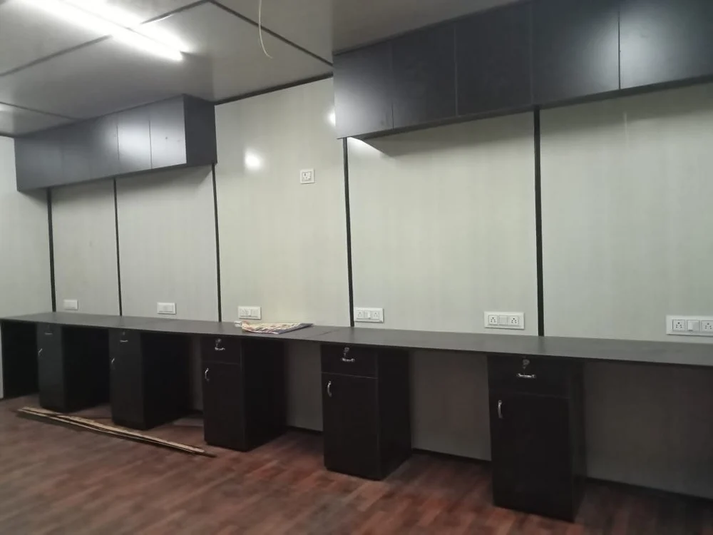 A modern interior of office container featuring sleek black cabinets and warm wooden floors, creating a stylish and inviting atmosphere - office and dry containers