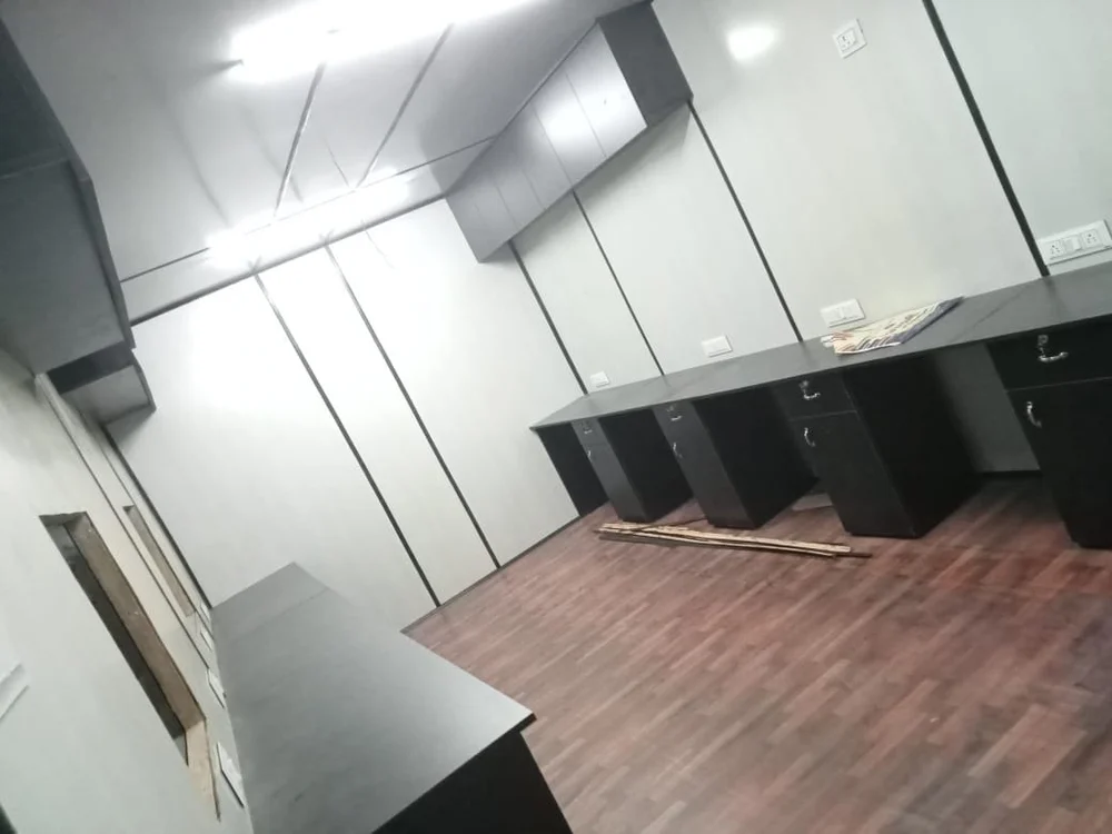 A portable office container with black cabinetry and polished wooden floors, offering a sophisticated and cozy environment - office and dry containers
