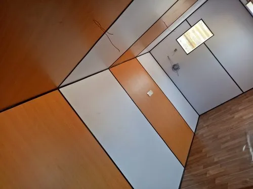 A portable office containers featuring orange and white walls complemented by elegant wooden flooring, creating a warm and inviting atmosphere - office and dry containers